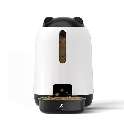 modern automatic pet feeder in white and black with cat ear lid, dispensing dry pet food into bowl, featuring transparent food level window and portion control design
